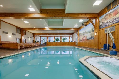a large swimming pool in a hotel room with a pool at Crowne Plaza Lake Placid, an IHG Hotel in Lake Placid