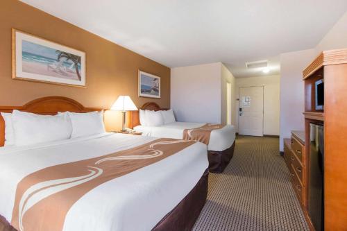a hotel room with two beds and a television at Quality Inn & Suites Crescent City Redwood Coast in Crescent City