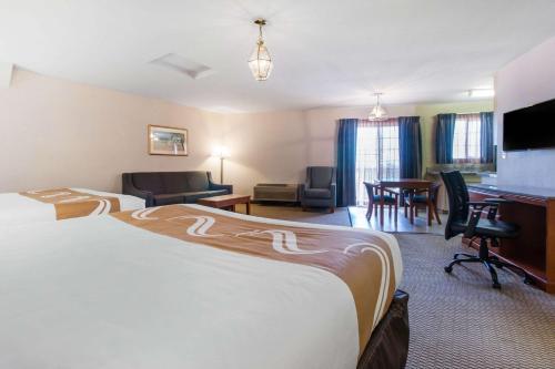 a hotel room with a large bed and a desk at Quality Inn & Suites Crescent City Redwood Coast in Crescent City
