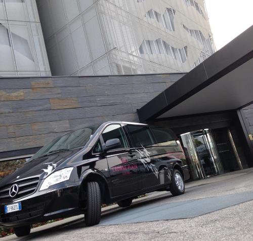 a black van parked in front of a building at Crowne Plaza Verona Fiera by IHG in Verona