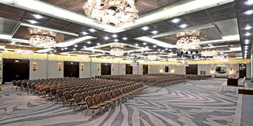 a large room with rows of chairs and chandeliers at Crowne Plaza Bursa Convention Center & Thermal Spa by IHG in Bursa