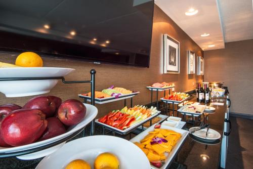 a buffet line with plates of food and fruit at Crowne Plaza Boston - Woburn by IHG in Woburn
