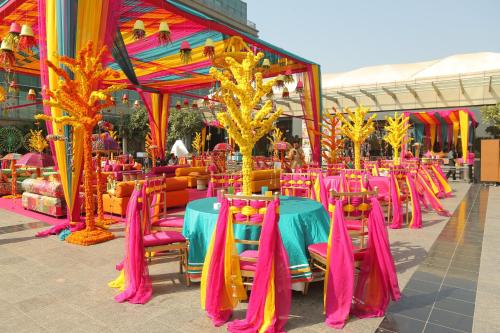 a group of tables and chairs in front of a building at Crowne Plaza New Delhi Rohini by IHG in New Delhi