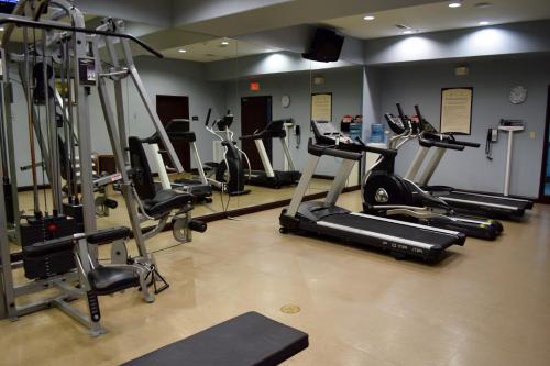 a gym with several tread machines in a room at Staybridge Suites Houston Stafford - Sugar Land by IHG in Stafford