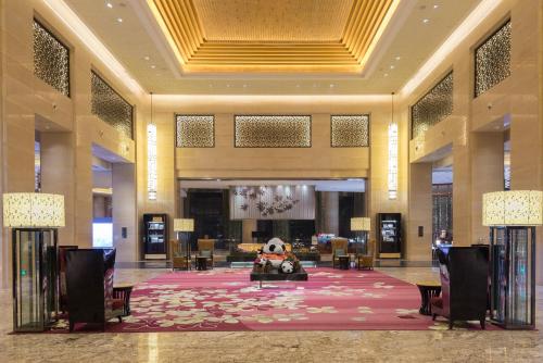 a lobby with a large lobby with a teddy bear in the middle at Crowne Plaza Chengdu Panda Garden, an IHG Hotel in Chengdu