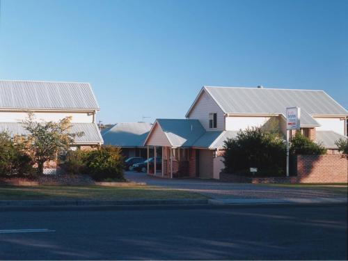 a row of houses with tin roofs on a street at Dolphin Shores in Vincentia