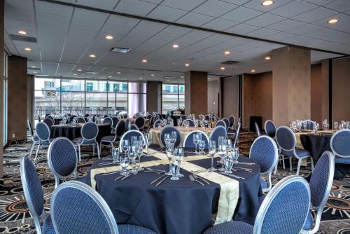 a conference room with tables and chairs with wine glasses at Fort Pontchartrain Detroit, a Wyndham Hotel in Detroit