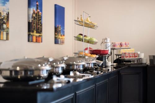a kitchen with pots and pans on a stove at Fort Pontchartrain Detroit, a Wyndham Hotel in Detroit