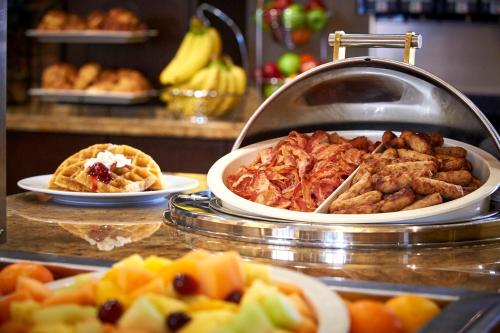 a buffet with different types of food on a counter at Staybridge Suites Hamilton - Downtown by IHG in Hamilton