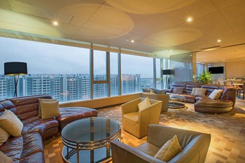 a living room with couches and tables and a large window at Crowne Plaza Guangzhou Huadu by IHG - Free Shuttle bus between hotel to Exhibition Center During Canton Fair in Guangzhou