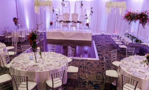 a wedding reception with white tables and chairs at Crowne Plaza Costa Mesa Orange County by IHG in Costa Mesa