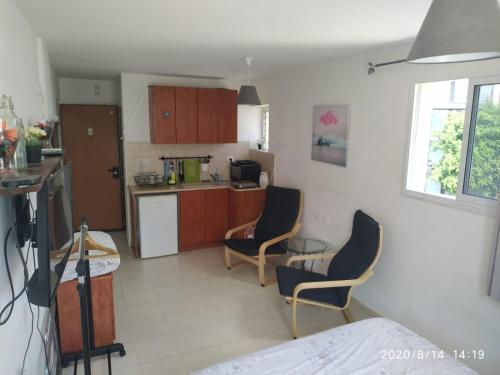 a kitchen with two chairs and a table at Amir's Apartments in Tel Aviv