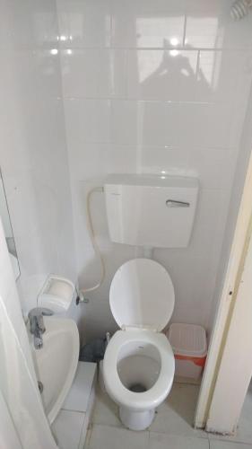 a small bathroom with a toilet and a sink at Amir's Apartments in Tel Aviv
