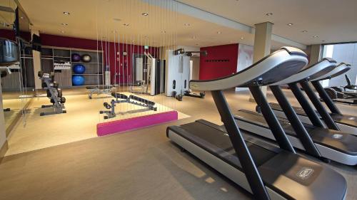 a gym with treadmills and machines in a room at Crowne Plaza Airport by IHG in Tocumen
