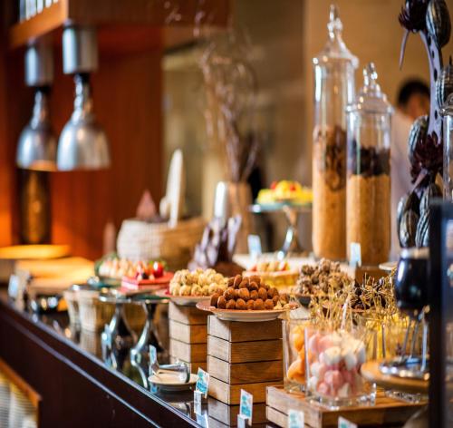 a buffet line with different types of food on display at Crowne Plaza Muscat OCEC by IHG in Muscat