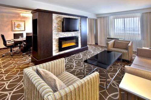 a living room with a couch and a fireplace at Crowne Plaza Kitchener-Waterloo, an IHG Hotel in Kitchener