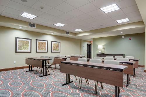 a conference room with tables and chairs in it at Staybridge Suites St Louis - Westport by IHG in Maryland Heights