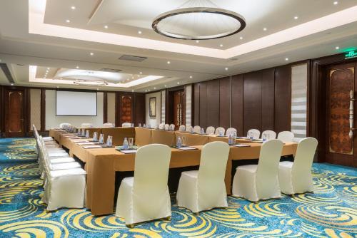 a large conference room with a large table and chairs at Junluxe Hotel Guangzhou Zengcheng-Free Shuttle Bus For Canton Fair in Zengcheng