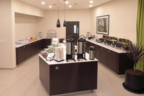 a kitchen with a counter with a bunch of food at Staybridge Suites San Luis Potosi by IHG in San Luis Potosí