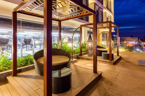 a balcony with a table and chairs on a building at Crowne Plaza Vientiane by IHG in Vientiane