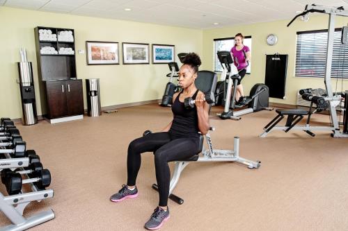 a woman sitting on a chair in a gym at Staybridge Suites West Edmonton by IHG in Edmonton