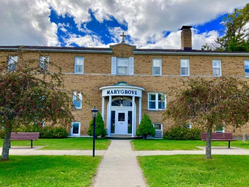 a large brick building with a sign that reads harvard at Garden Grove Retreat & Lodging near Pictured Rocks, Fayette, Trails in Garden