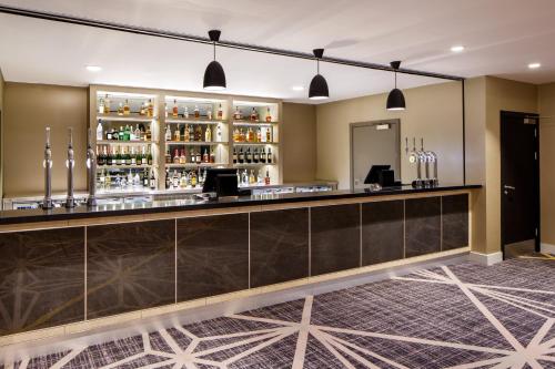a bar in the lobby of a hotel at Crowne Plaza Aberdeen Airport by IHG in Dyce