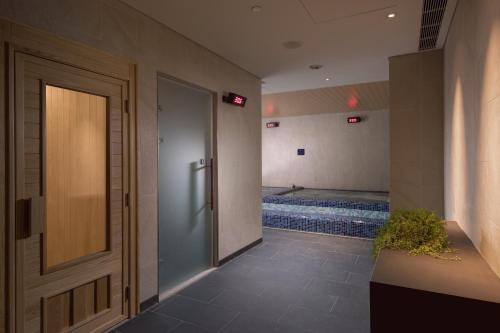 a hallway with a door and a swimming pool at Crowne Plaza Tainan by IHG in Tainan