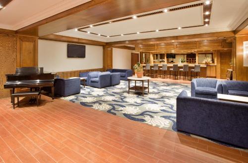 a large room with a piano and chairs at Wyndham Gatineau-Ottawa & Conference Centre in Gatineau