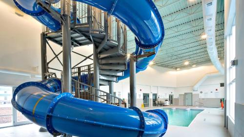 a water slide in a gym with a pool at Staybridge Suites - Red Deer North by IHG in Red Deer