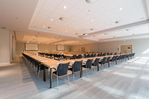 a large room with a long table and chairs at Crowne Plaza Utrecht - Central Station by IHG in Utrecht