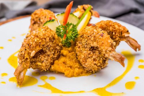 a white plate with food on it with vegetables at Crowne Plaza Barranquilla by IHG in Barranquilla