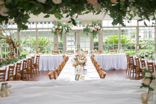a wedding reception with tables and chairs and flowers at Crowne Plaza Hawkesbury Valley by IHG in Windsor