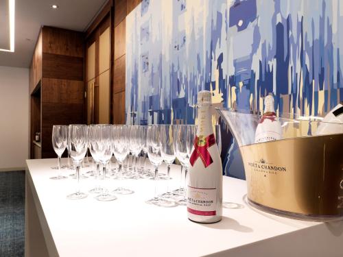 a table with wine bottles and wine glasses at Crowne Plaza London Kings Cross by IHG in London