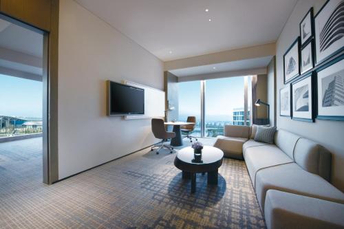 a living room with a couch and a table at Crowne Plaza Shenzhen World Exhibition and Convention Center by IHG in Shenzhen