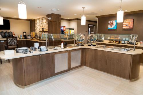 a restaurant with a counter with dishes on it at Staybridge Suites - Washington DC East - Largo by IHG in Largo