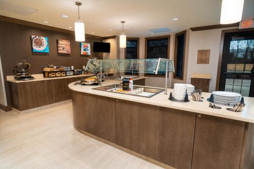 a restaurant kitchen with a counter with plates on it at Staybridge Suites - Washington DC East - Largo by IHG in Largo
