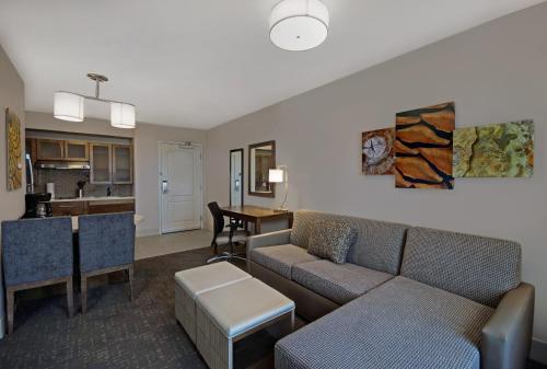 a living room with a couch and a table at Staybridge Suites Sterling Heights - Detroit by IHG in Sterling Heights