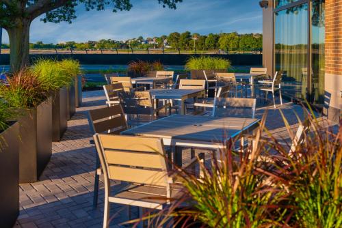 a row of tables and chairs on a patio at Staybridge Suites - Boston Logan Airport - Revere by IHG in Revere