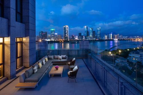 a balcony with a view of the city at night at Crowne Plaza Fuzhou South by IHG in Fuzhou