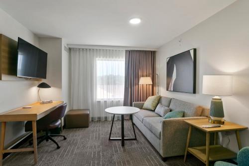 a living room with a couch and a table in a hotel room at Staybridge Suites - Atlanta NE - Duluth by IHG in Duluth