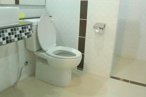 a bathroom with a white toilet in a room at City Ratsada Lampang in Lampang