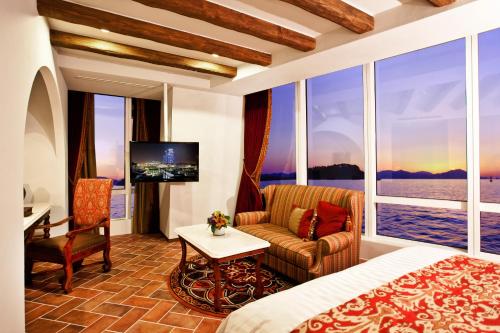 a hotel room with a bed and a tv at Sono Calm Yeosu in Yeosu