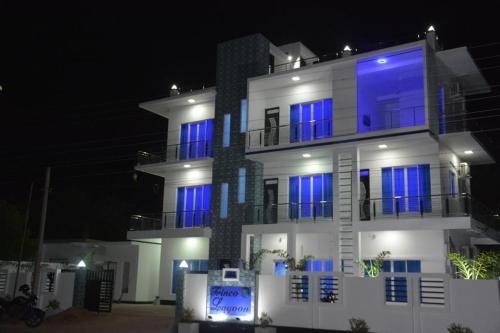 a large white building with blue windows at night at Trinco Lagoon in Trincomalee