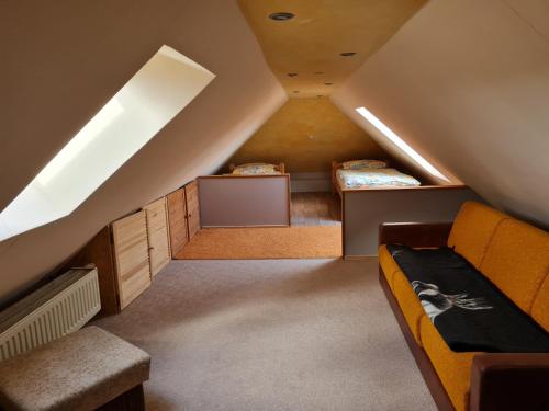 a attic room with two beds and a desk at Ferienhaus mit 2 FeWo in Mecklenburg in Wesenberg