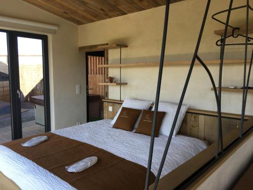 a bedroom with a large bed in a room at Beau Réveil nature & wellness - gite 1 in Manhay