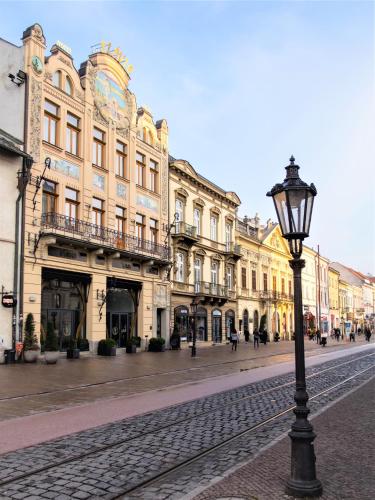a street light on a cobblestone street with buildings at Boutique Hotel Slávia in Košice