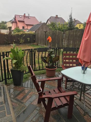 a patio with a table and two chairs and a table at Penzion SLUNCE in Česká Lípa