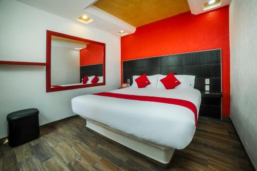 a bedroom with a large bed with a red wall at Hotel SR92 Adults Only in Mexico City