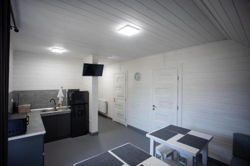 a kitchen with a table and a sink in a room at GARAGE in Yaremche
